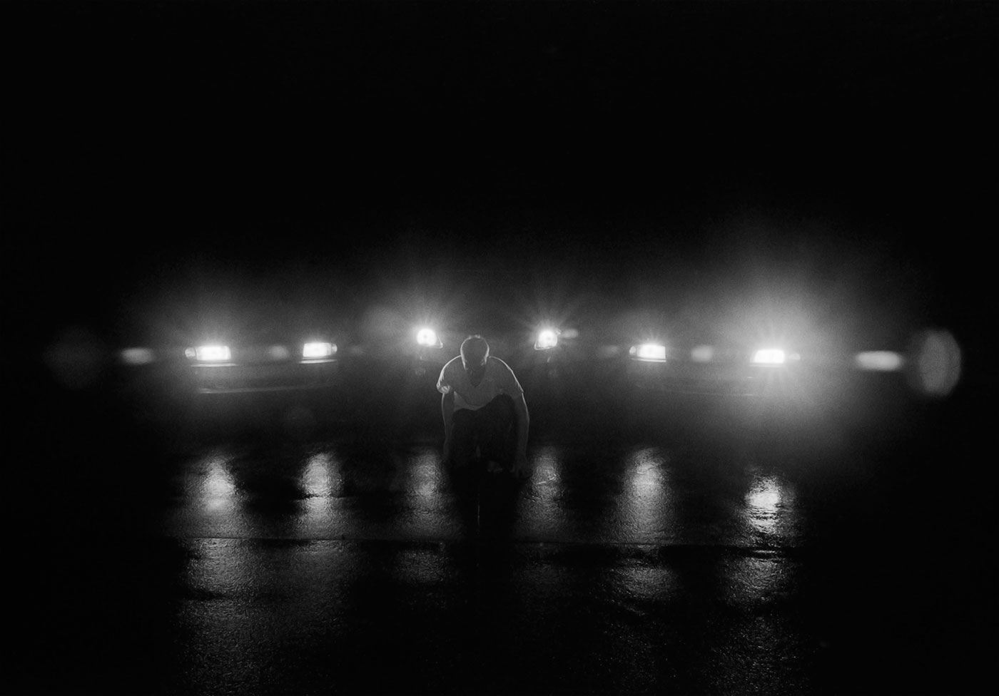 Man kneeling with lights surrounding